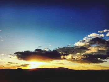 Low angle view of silhouette landscape against sunset sky