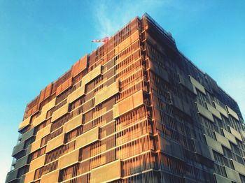 Low angle view of modern building against blue sky