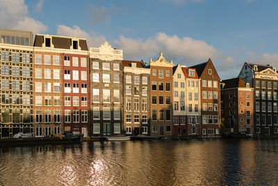 Historical buildings of amsterdam in the sunset light.