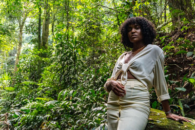 Portrait of woman standing in forest