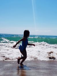 Full length of woman on beach against sky
