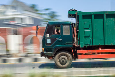 Blurred motion of truck on road in city
