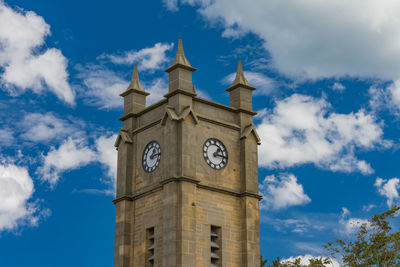 Low angle view of clock tower against sky