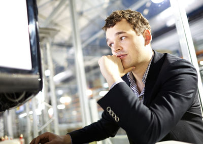 Happy man using computer at office