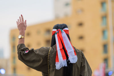 Rear view of man standing in traditional clothing