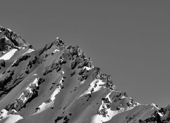 Scenic view of snowcapped mountains against clear sky