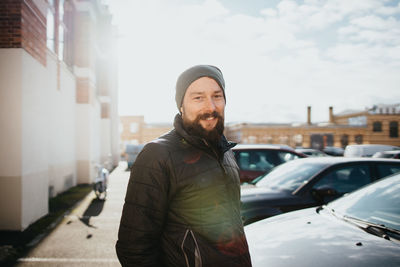 Portrait of smiling man standing in city