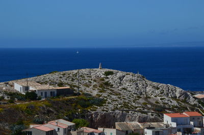 High angle view of buildings by sea against sky