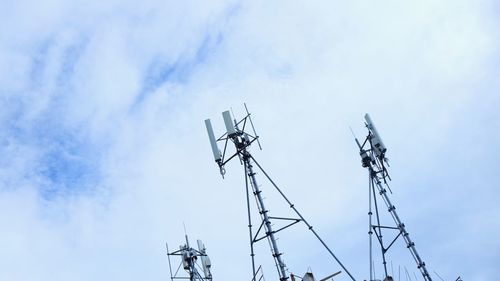 Low angle view of communications tower against sky