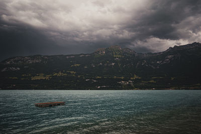 Scenic view of sea and mountains against sky