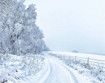 Snow covered field against sky