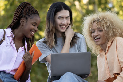 Group of students happy smiling outdoors with their laptop. career university success concept