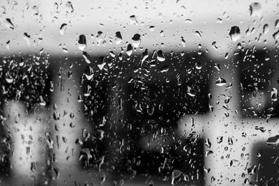 Full frame shot of wet glass window in rainy season