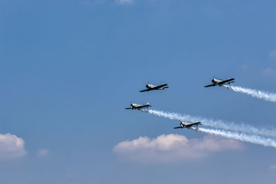 Low angle view of airshow in sky