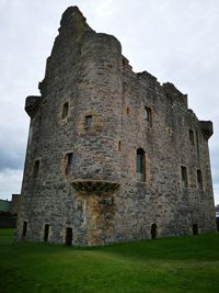 Low angle view of old ruin building against sky