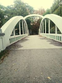 Narrow footbridge over river in park