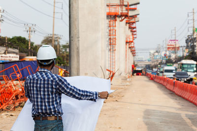 Rear view of man standing in city