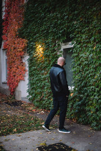 Young man standing against wall