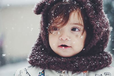 Close-up of cute baby girl wearing knit hat during winter