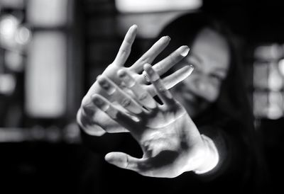 Woman showing stop gesture in room