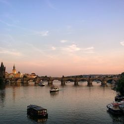 Boats in river with city in background