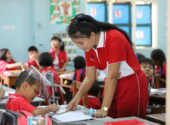 Teachersand students are studying in school in thailand.