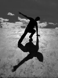 Low angle view of silhouette man at skateboard park 