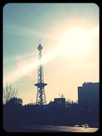 Communications tower against sky during sunset