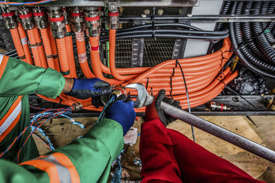 Low angle view of man working on metal structure