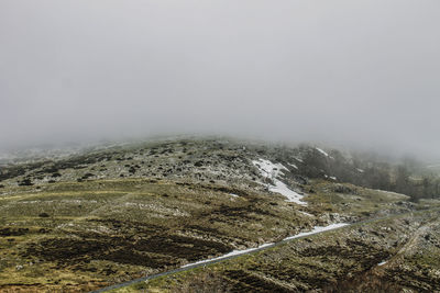 Scenic view of landscape against cloudy sky