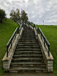 Low angle view of staircase on field against sky