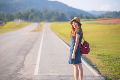 Portrait of woman standing on road