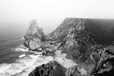 High angle view of rocks in sea against sky