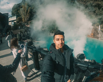 Portrait of young man standing outdoors