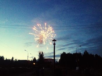 Low angle view of illuminated street light against sky