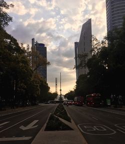 View of city street and buildings against sky