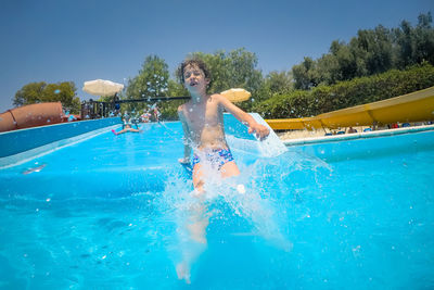 Man surfing in swimming pool