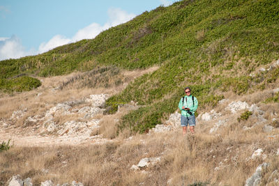 Full length of man on arid landscape against sky