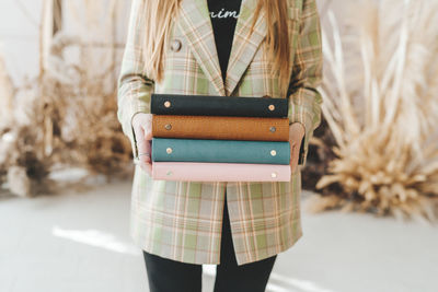 Business woman in a suit holds colored notebooks. student with a stack of notebooks. girl with book 