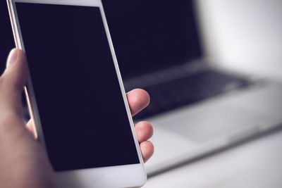 Close-up of hand holding mobile phone