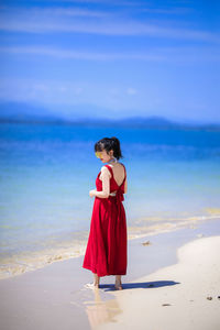 Woman standing on beach against sea