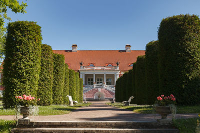 View of building and trees against sky