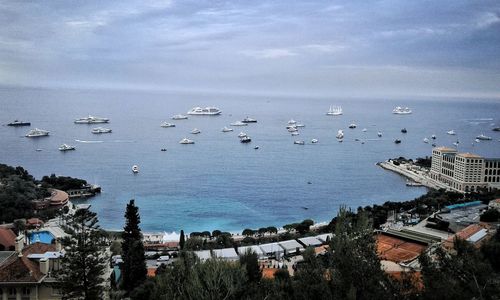 High angle view of sea by cityscape against sky