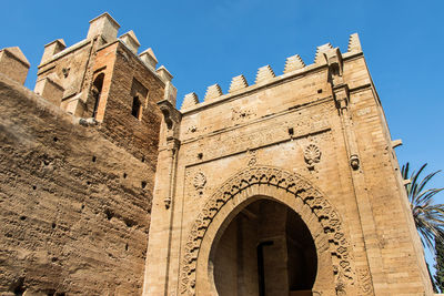 Low angle view of historical building against clear blue sky