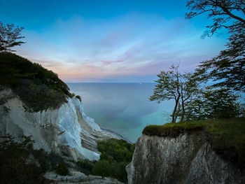 Panoramic shot of rocks by sea against sky