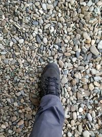 Low section of person standing on stones