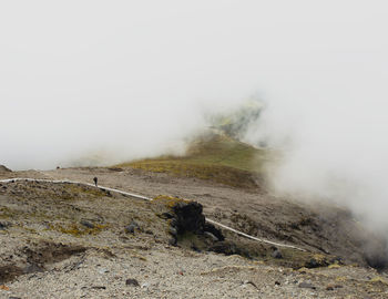 Scenic view of landscape amidst fog