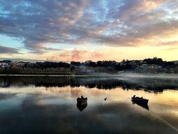 Scenic view of lake at sunset