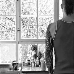 Close-up of woman standing against white wall