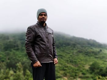 Portrait of young man standing outdoors